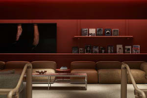 A modern living room featuring fabric upholstery, wooden accents, and metallic elements.