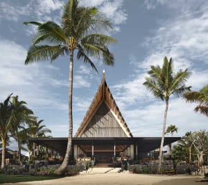 A modern residential exterior featuring architectural design and wooden elements.