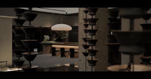 Modern restaurant interior with concrete floors, metal railings, and glass walls