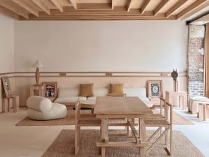 A modern living room featuring wooden furniture and neutral color palette.