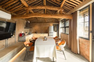Industrial-style residential kitchen featuring natural wood elements and minimalistic design.