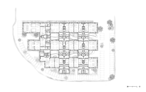 Residential apartment building layout on paper with multiple rooms and corridors.