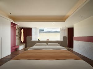 A modern residential bedroom featuring a bed with terrazzo and concrete textures, minimalistic design, and red accents.