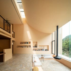 Modern living room featuring transparent ceiling, neutral-toned furniture, and a comfortable seating area.
