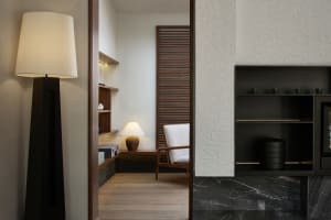 A modern living room with wooden furniture and marble accents.