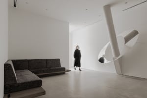 A modern interior space featuring concrete and glass materials.