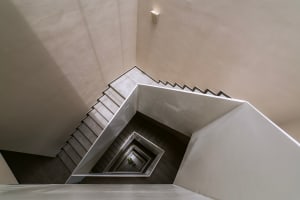 Modern, minimalist concrete staircase photographed from multiple angles.