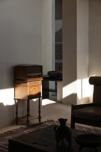A modern living room with wooden furniture and minimalist decor.