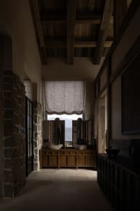 Industrial-style interior with wooden walls, exposed beams, and stone accents.