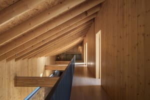 Modern interior design featuring wooden walls and floors.