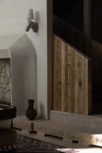 Modern indoor staircase with wooden paneling and stone steps.