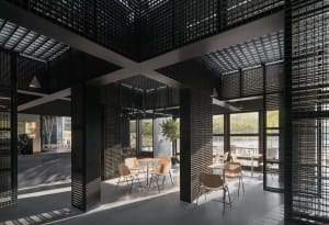 Modern industrial cafe interior with concrete, glass, and wood details.