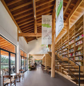 A modern, industrial-style library with an extensive collection of books and a warm, wooden interior.