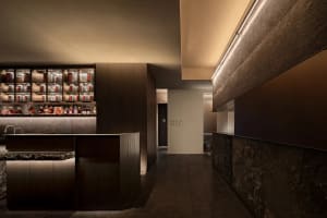 A modern bar with wooden elements and concrete flooring.