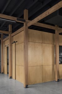 Industrial-inspired interior design featuring wooden panels, showcasing a modern, minimalist aesthetic in a workspace setting