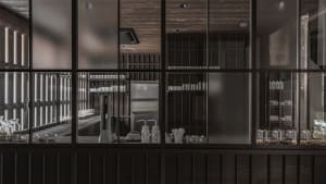 A modern commercial kitchen with metal shelves and various items.
