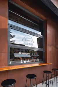 Modern storefront with large glass windows and metallic elements