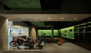 An industrial motorcycle showroom featuring concrete floors and walls.