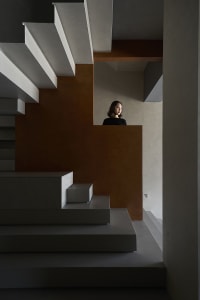 A modern interior with a concrete staircase and minimalist design.