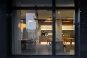 A minimalist modern coffee shop with wooden furniture and open layout.