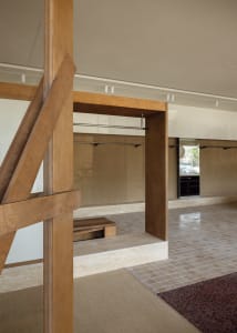 Minimalist living space with wood, tile, and carpet flooring.