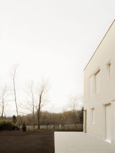 Modern house with a concrete exterior and minimalist design, featuring a clean, contemporary look.