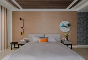 A modern minimalist bedroom featuring neutral tones, a stylish bed with a headboard, and sleek, functional nightstands.