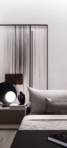 A minimalist bedroom with a glass partition and fabric elements.