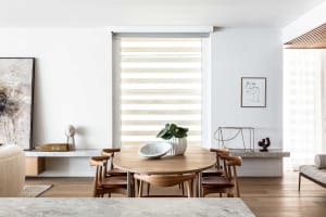 A modern minimalist dining room featuring wooden furniture and stylish decor.