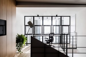 A modern office space with glass walls and a minimalist design.