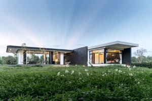 Modern home with glass walls, concrete and metal exterior