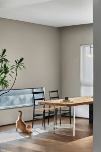 Modern living and dining room with wood, glass, and metal elements