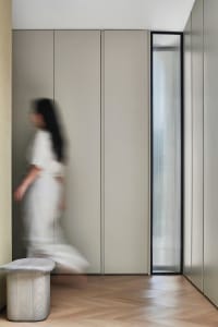A minimalist interior design featuring metallic surfaces and translucent glass elements.