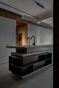 Modern, minimalist kitchen with concrete countertop and dark wood cabinets