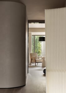 Modern minimalist living room featuring a white curtain and column.