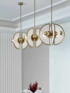 Modern interior design featuring a brass and glass chandelier.