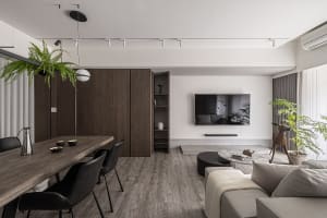 Modern living and dining room with a combination of materials and minimalist design.