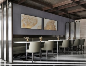 Modern restaurant interior featuring black, white, glass, and metal elements.