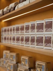 A wooden shelf with neatly arranged boxes containing books and small objects, showcasing a sense of orderliness and organization