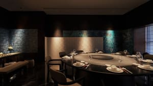 Sophisticated dining space with a round table, wine glasses, and decorative bowls and cups