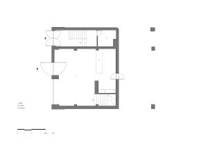 Empty single-story house with a flat roof, featuring a central staircase and a secondary staircase on the right side, with a minimalist design and clean lines
