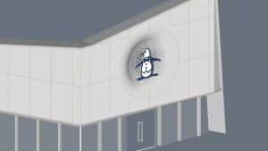 A modern building with a penguin logo on its side, featuring white walls and a large window