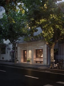A modern building with a white facade, featuring a large window and two benches in front, with a bicycle parked nearby, set in a calm and inviting atmosphere