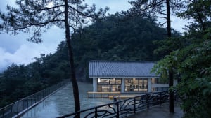 Modern restaurant with a mountain view, featuring a dining area with multiple chairs and a stylish design