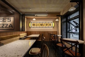 Inviting dining space with multiple tables and chairs, surrounded by comfortable seating and warm atmosphere