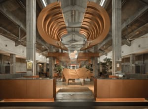 A large wooden sculpture dominates the interior of a building with a focus on artistic expression and appreciation