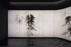 a black and white image of a tree surrounded by water, creating a calm atmosphere