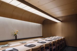 Empty restaurant dining space with wooden tables and chairs, clean and well-organized, warm and inviting atmosphere