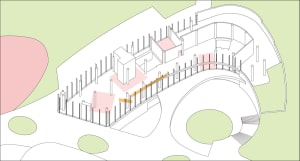 A spacious interior space with white walls, columns, and a fence, featuring a clean and bright atmosphere