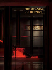 A dark and moody gallery with a prominent staircase made of red glass, creating a sense of mystery and intrigue